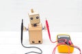 Robot holds voltmeter. horizontal