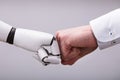 Robot And Human Hand Making Fist Bump