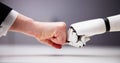 Robot And Human Hand Making Fist Bump Royalty Free Stock Photo