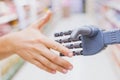 Robot and human hands in handshake, high tech in everyday life Royalty Free Stock Photo