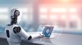 Robot humanoid use laptop and sit at table for big data analytic Royalty Free Stock Photo