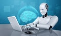 Robot humanoid use laptop and sit at table in concept of AI thinking brain Royalty Free Stock Photo