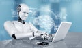 Robot humanoid use laptop and sit at table in concept of AI thinking brain Royalty Free Stock Photo