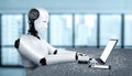 Robot humanoid use laptop and sit at table in future office