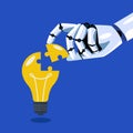 Robot inserts the missing puzzle in lightbulb Royalty Free Stock Photo