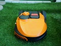 Robot lawn mower on grass, Close up and front view Royalty Free Stock Photo