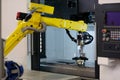robot loading workpieces into CNC machining center