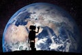 Robot looking on the planet Earth from space. Technology concept, artificial intelligence