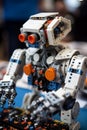 Robot made of construction set blocks types on keyboard AI generative image