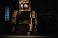 A robot made out of cardboard boxes in a dark room. AI generative image. Royalty Free Stock Photo