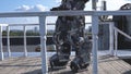 Robot moves his hands on background of city skyline and blue sky. Footage. Concept of technologies with artificial
