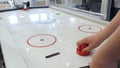 Robot plays with a man in table hockey. Media. High technologies of robots development