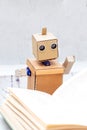Robot with hands read book. Artificial Intelligence Royalty Free Stock Photo