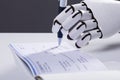 Robot Signing Cheque Royalty Free Stock Photo