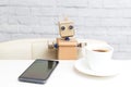 Robot sits at the table and drinks coffee. Artificial Intelligen