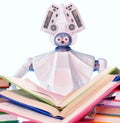 Robot teacher with book for kid. White plastic robotic device.