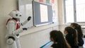 Robot teaching a class of students in front of a whiteboard in school Royalty Free Stock Photo