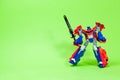Robot transformer red and blue on green background with space for text. Toys for children, toy store. 25 April 2022 Royalty Free Stock Photo