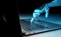 Robot using a laptop. Cyborg hand pressing a keyboard with his finger. 3D rendering Royalty Free Stock Photo
