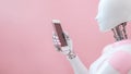 AI robot using smartphone on pink background