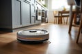 Robot vacuum cleaner on the floor of a kitchen Royalty Free Stock Photo