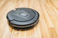 Robot vacuum cleaner on laminate wood floor, Home Smart robotic. Royalty Free Stock Photo