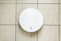 Robot vacuum cleaner and mop cleaning kitchen tiles floor from above. Top view of modern smart device for everyday housekeeping