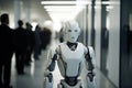 Robot Walks Down Office Corridor, With Unfocused People In Business Suits Sitting In The Background. The Concept Of Replacing