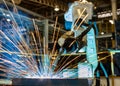 Robot is welding metal part in car factory Royalty Free Stock Photo