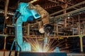 Robot is welding metal part in car factory Royalty Free Stock Photo