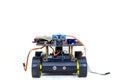 Robot on wheels with different wires on a light background
