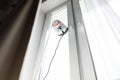 Robot window cleaner work on dirty window. Cleaning the house with smart devices. Automatic vacuum robots for cleaning Royalty Free Stock Photo