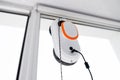 Robot window cleaner work on dirty window. Cleaning the house with smart devices. Automatic vacuum robots for cleaning Royalty Free Stock Photo