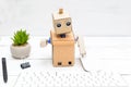 The robot works behind the computer on the keyboard