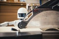A robot works fully automatically in a carpentry workshop