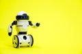 Robot on a yellow background with a place for text for a toy store and children's technology centers. Royalty Free Stock Photo