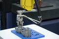 The robotic arm catch the aluminum part .