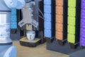 Robotic arm close-up. Background in various colors. While robotic arm cups