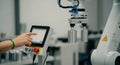 Robotic Arm Control Panel Hand Interacting with Touchscreen Display in a Factory Setting Royalty Free Stock Photo