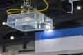 The robotic arm gripping the plastic container part at injection machine