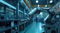 A robotic arm is maneuvering precision tools in a high-tech manufacturing facility. Workers can be seen in the Royalty Free Stock Photo