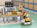 Robotic arm picking parcel from conveyor to AGV Royalty Free Stock Photo