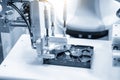 The robotic arm picking up the circuit board parts assembly in the hard disk part. Royalty Free Stock Photo