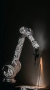 Robotic arm projecting intricate floral patterns onto a surface, blending technology and art in a captivating dark environment Royalty Free Stock Photo