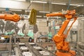 Robotic automatic arm in the factory for precise production and joining of individual parts into a whole. robotization