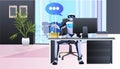 robotic businessperson sitting at workplace in office chat bubble communication artificial intelligence technology