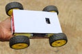 Robotic car having 4 wheels all powered by powerful plastic geared motors held in hand. Smartphone controlled robotic car project