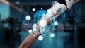 Futuristic robot hand reaching out to human hand with global connectivity and digital network symbols in a modern office Royalty Free Stock Photo