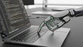 Robotic hand with green glowing joints typing on a laptop keyboard displaying lines of code on screen Royalty Free Stock Photo
