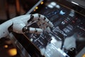 Robotic hand interacting with touchscreen interface in a high-tech environment showcasing advanced technology and innovation Royalty Free Stock Photo
